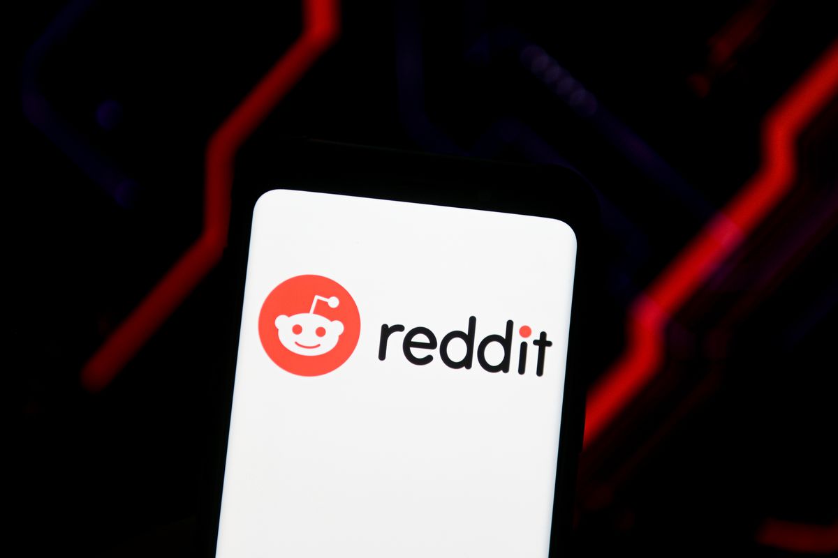 In this photo illustration a Reddit logo seen displayed on a...