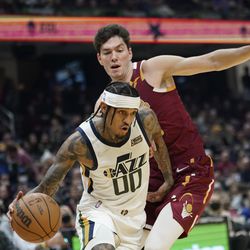 Utah Jazz’s Jordan Clarkson (00) drives against Cleveland Cavaliers’ Cedi Osman (16) in the first half of an NBA basketball game, Sunday, Dec. 5, 2021, in Cleveland. 