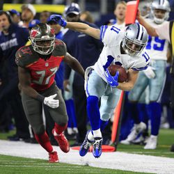 Dallas Cowboys wide receiver Cole Beasley (11) tries to stay inbounds after catching a pass as Tampa Bay Buccaneers' Keith Tandy (37) pursues in the second half of an NFL football game, Sunday, Dec. 18, 2016, in Arlington, Texas. 