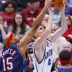 Utah Jazz's Andrei Kirilenko has his shot blocked by New Jersey Net Vince Carter in action Jan 29, 2005 at the Delta Center in Salt Lake City.  