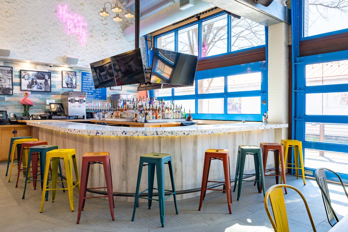 A U-shaped bar with colorful stools.