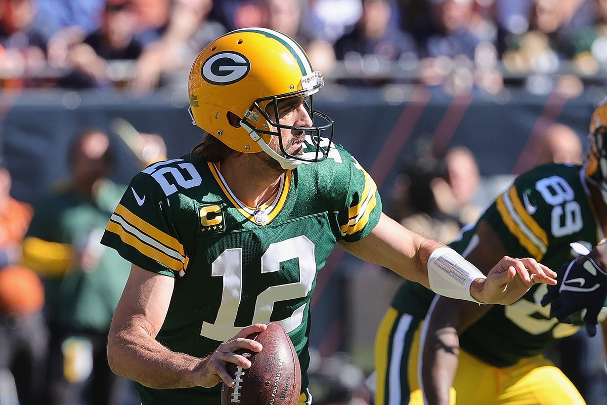 Aaron Rodgers #12 of the Green Bay Packers rolls out to look for a receiver against the Chicago Bears at Soldier Field on October 17, 2021 in Chicago, Illinois. The Packers defeated the Bears 24-14.