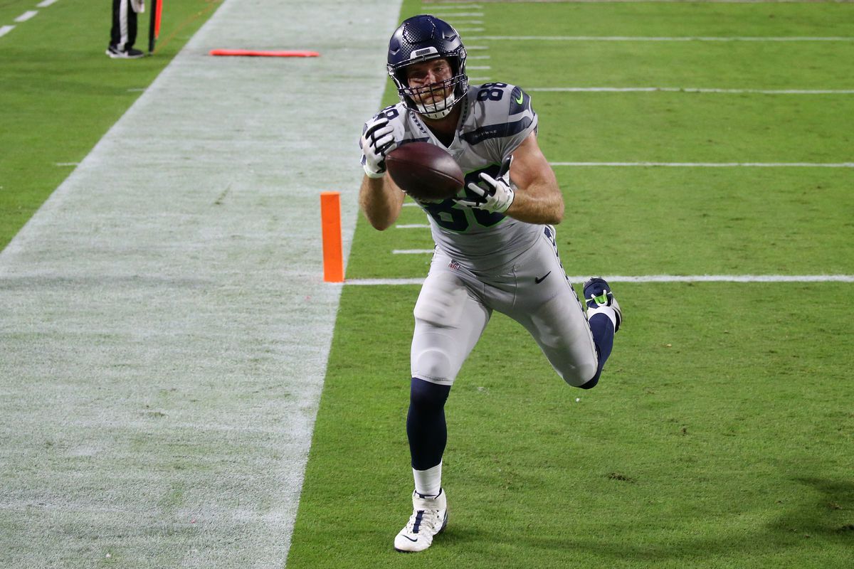 Tight end Greg Olsen #88 of the Seattle Seahawks catches a touchdown pass with one foot down in the end zone in the first quarter of the game against the Arizona Cardinals at State Farm Stadium on October 25, 2020 in Glendale, Arizona.