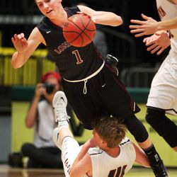 Tyson Doman of Lone Peak is fouled by Braden Condie of American Fork during boys high school basketball in Orem, Tuesday, Feb. 10, 2015.