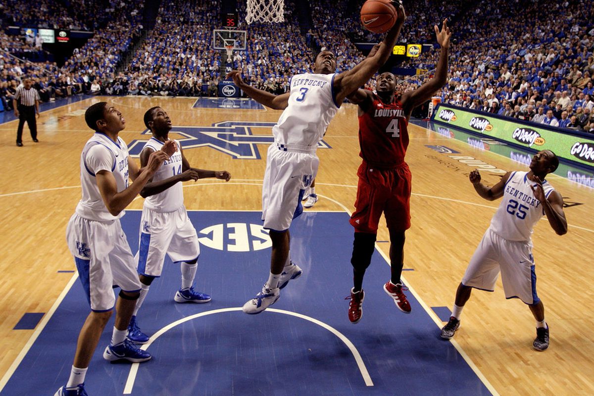 Four white shirts in this view illustrates why the Kentucky Wildcats dominated the Louisville Cardinals on the glass Saturday -- team rebounding.
