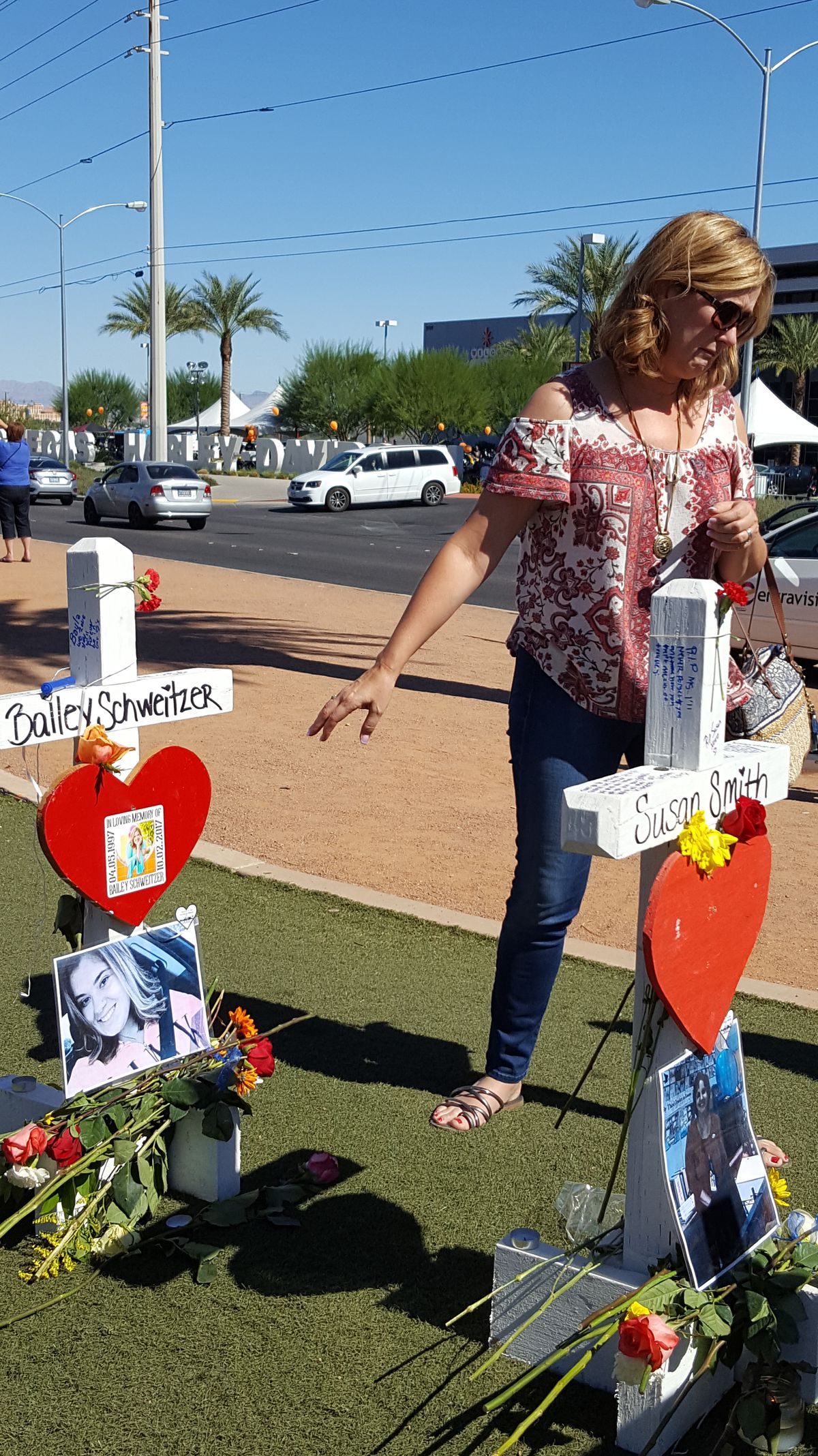 A family friend walks away from the cross of 20-year-old Bailey Schweitzer, one of the 58 victims of the Oct. 1 mass shooting in Las Vegas. | Miriam Di Nunzio