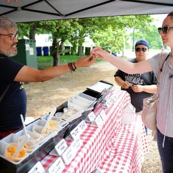 Eduardo Rodriguez passing out cheese samples | Victor Hilitski/For the Sun-Times