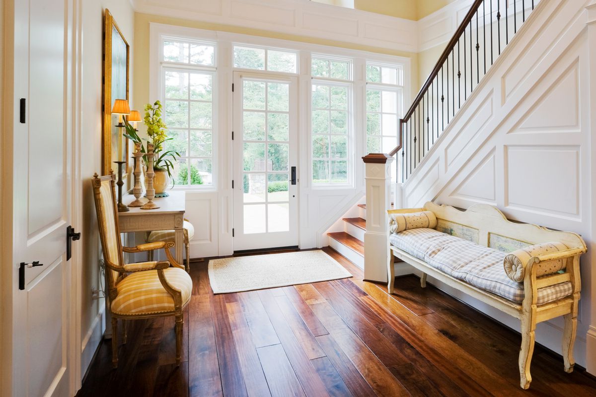 Foyer with wood flooring and staircase.