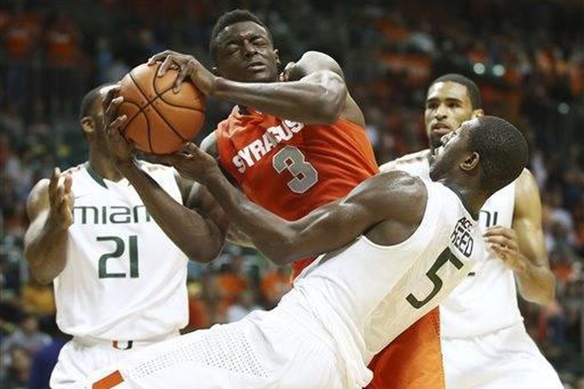 Miami's Davon Reed (5) and Syracuse's Jerami Grant (3) battle for the ball during the second half of an NCAA college basketball game in Coral Gables, Fla., Saturday, Jan. 25, 2014. Syracuse won 64-52. (AP Photo/J Pat Carter)