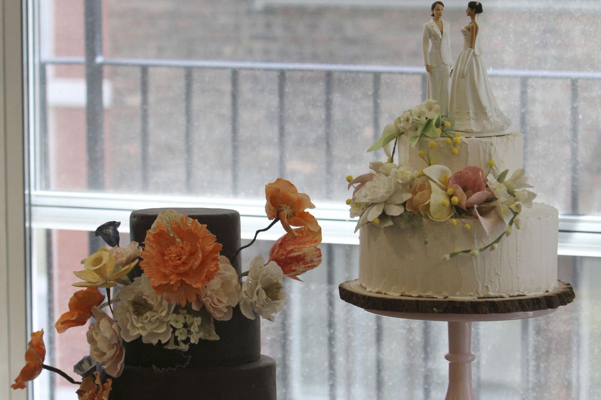 An almond cake with New York City rooftop honey buttercream icing, right, and a chocolate cake with chocolate gnash icing are on display at the Sugar Flower Cake Shop, Monday, June 27, 2011 in New York.