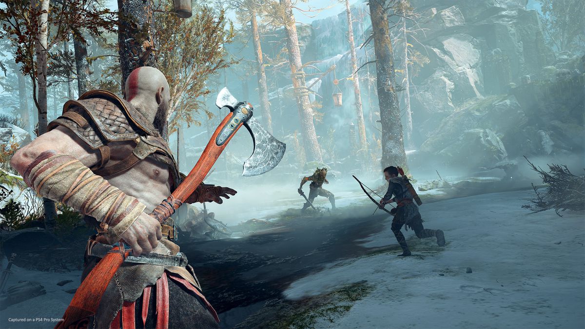 Kratos holding an ax in a wintry forest