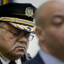 Philadelphia Police Commissioner Charles Ramsey, left, listens as District Attorney Seth Williams speaks during a news conference, Thursday, Feb. 5, 2015, in Philadelphia. Two Philadelphia police officers face brutality charges after prosecutors say they knocked a man off a scooter and beat him so severely another officer thought the bloodied man had been shot. 
