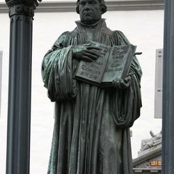A bronze sculpture of Martin Luther holding the New Testament is seen on the market square in Wittenberg, eastern Germany, Tuesday, Oct. 31, 2006. German priest and church reformer Martin Luther on Oct. 31, 1517, pinned his controversial 95 theses on the door of the Wittenberg castle church. Since 1667, Protestant Christian have celebrated Reformation Day on Oct. 31.