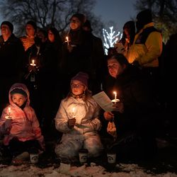 Brenda Somers, right, Astryd, 11, center, and Lilly, 6, along with other participate in the 2021 Homeless Persons Memorial Candlelight Vigil at Pioneer Park in Salt Lake City on Tuesday, Dec. 21, 2021. The vigil honored the 116 men and women who died in Salt Lake City while experiencing homelessness over the past year.