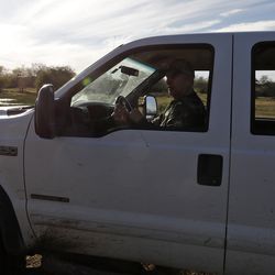Ty Detmer parks his pickup during a hunt on his T14 Ranch Thursday, Nov. 15, 2018, near Freer, Texas.