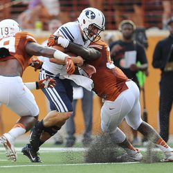 BYU's quarterback Taysom Hill fights for yardage as BYU and Texas play Saturday, Sept. 6, 2014, in Austin, Texas.