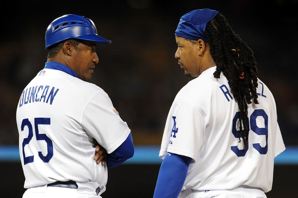 Coach Mariano Duncan talks with Manny Ramirez of the Los Angeles Dodgers. One of these people is joining the Cubs organization as Double-A hitting coach. (Hint: it's not the guy on the right.)  (Photo by Lisa Blumenfeld/Getty Images)