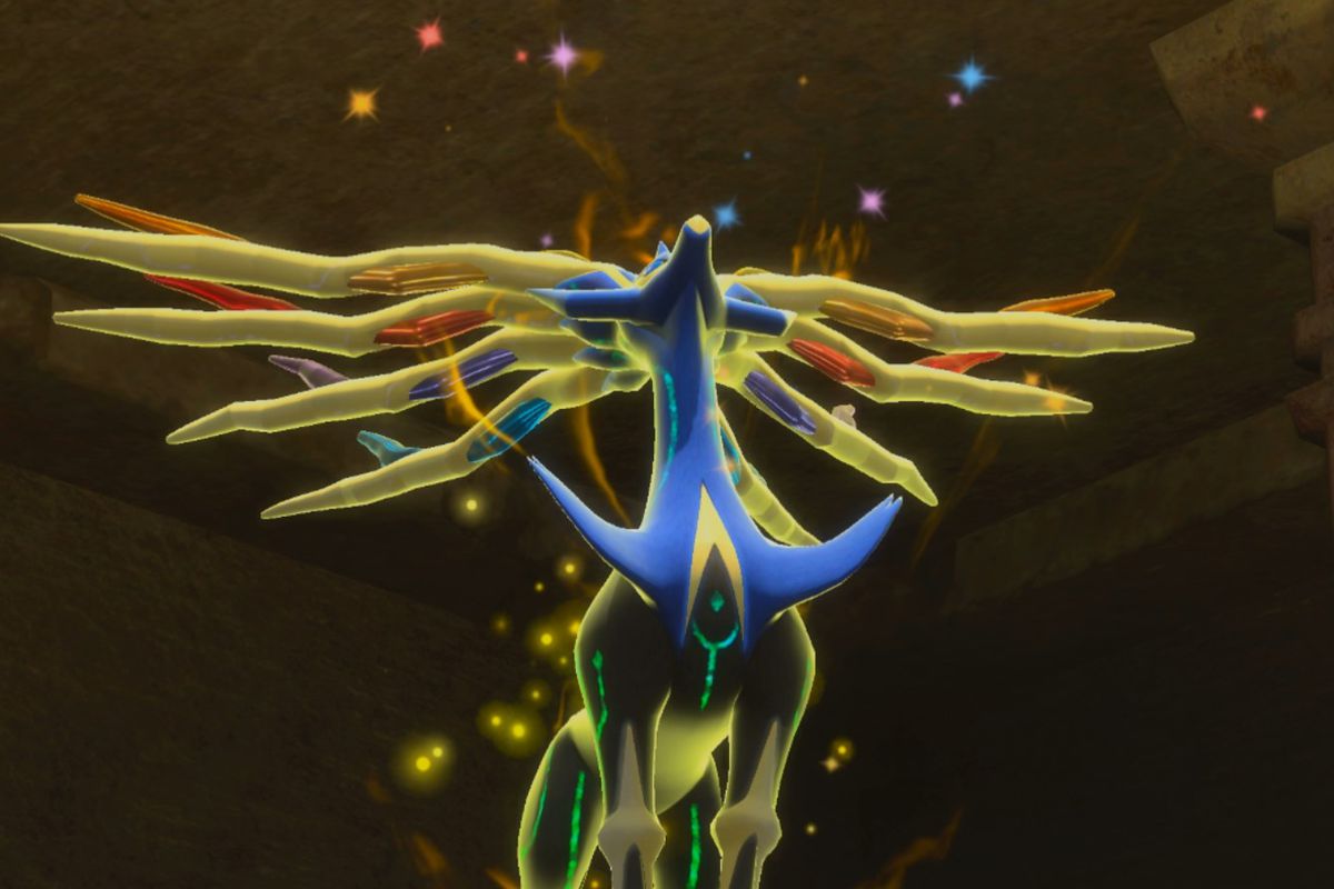 Xerneas looks up at the sky while it has a golden glow