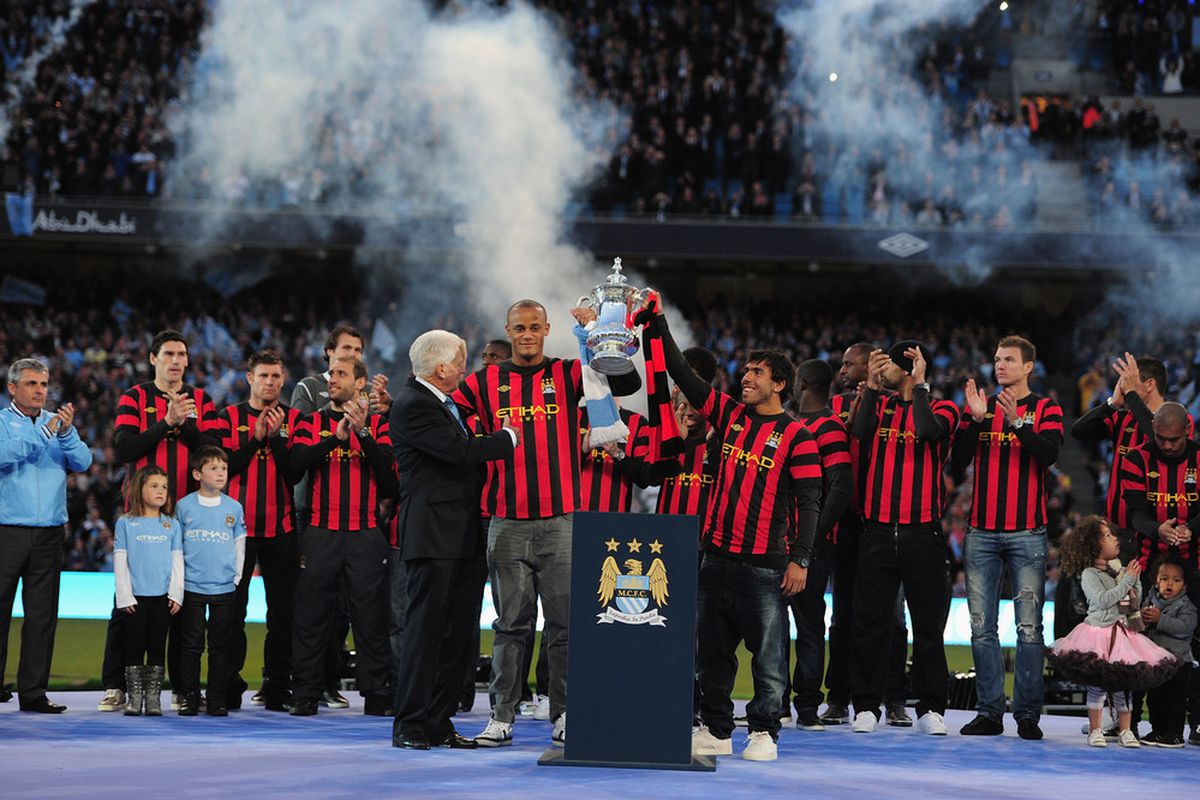 MANCHESTER, ENGLAND - MAY 23:  The Manchester City team enjoy the moment Manchester City FA Cup Winners Parade at the City of Manchester stadium on May 23, 2011 in Manchester, United Kingdom.  (Photo by Jamie McDonald/Getty Images)