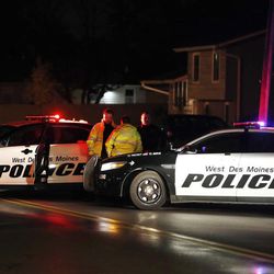 Law enforcement officials investigate at the scene of a shooting, Wednesday, Nov. 2, 2016, in Urbandale, Iowa. Two Des Moines area police officers were shot to death early Wednesday in ambush-style attacks while they were sitting in their patrol cars, and police are searching for suspects, authorities said. 