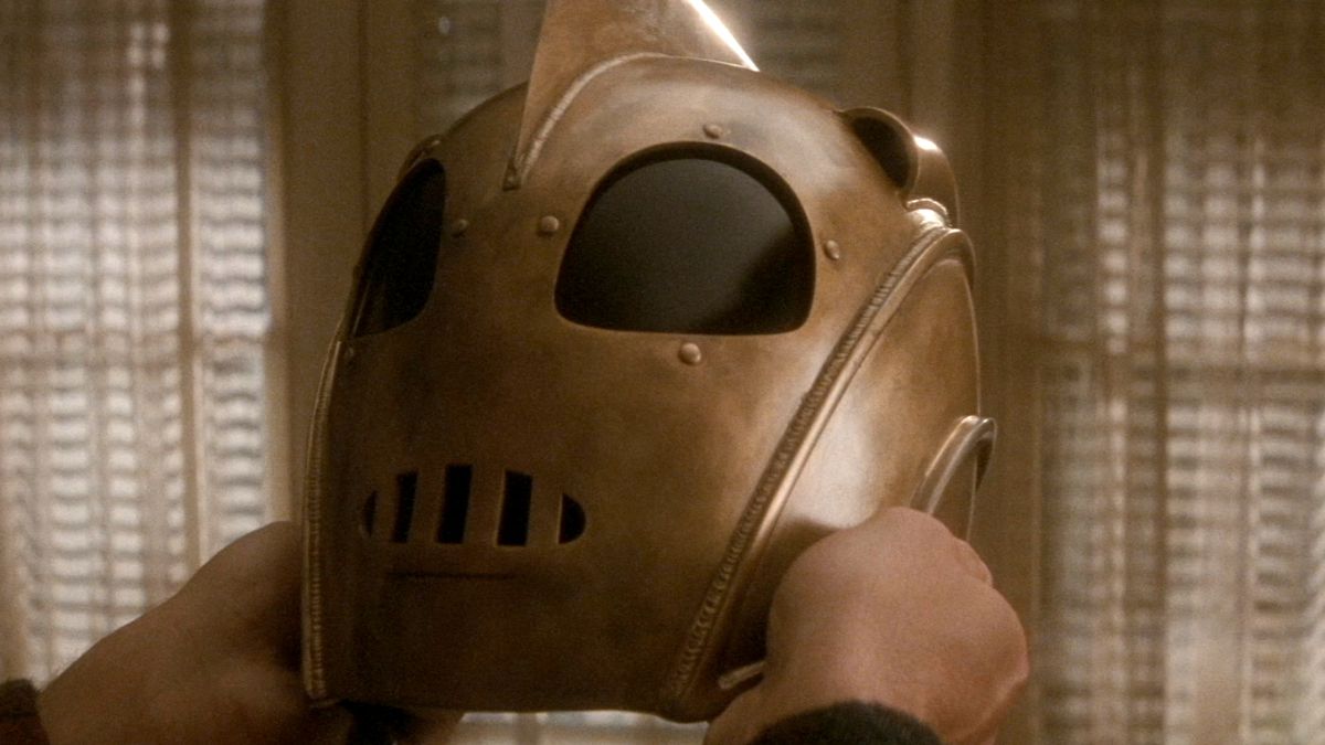 the rocketeer holds his helmet for a close-up