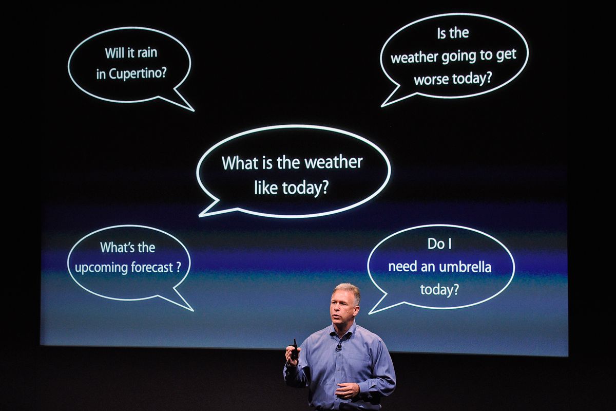 Phil Schiller, Apple’s senior vice president of worldwide product marketing, onstage in front of a screen depicting word bubbles.