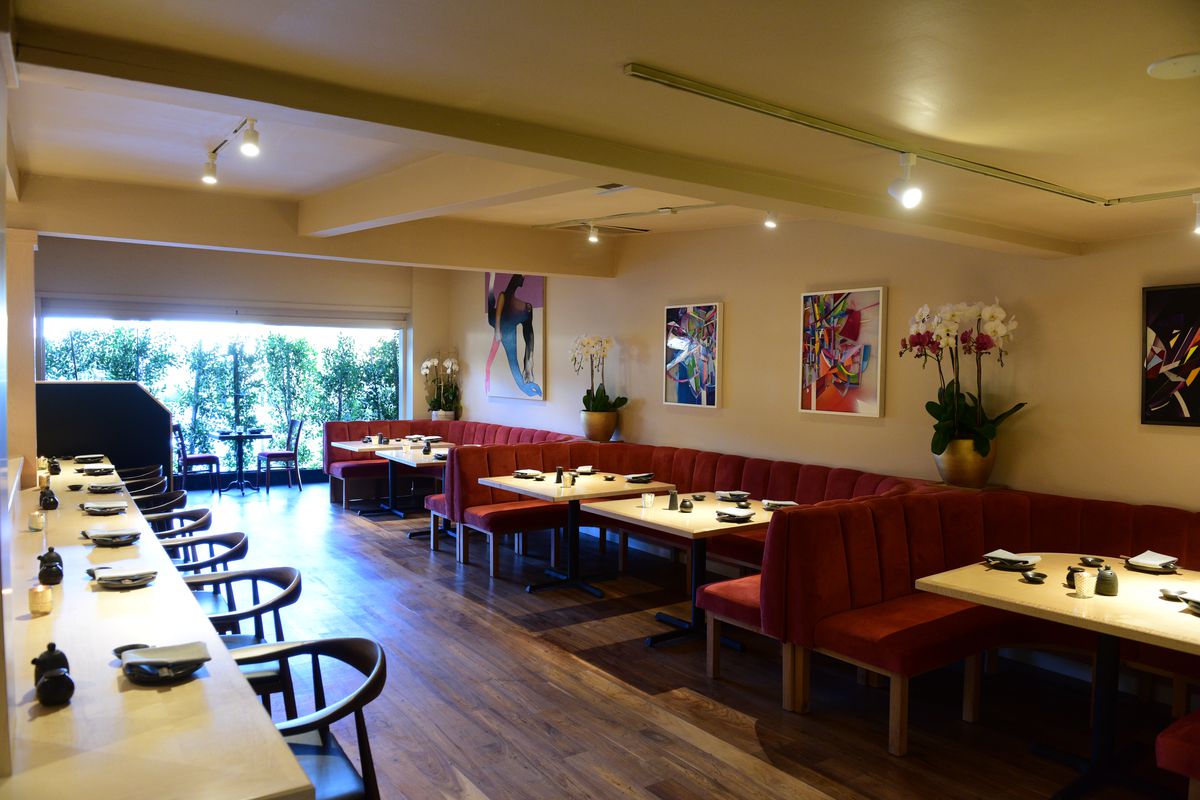 A restaurant with a sushi bar seating area, dining tables, and outdoor patio at Leona’s Sushi House in Studio City, California.