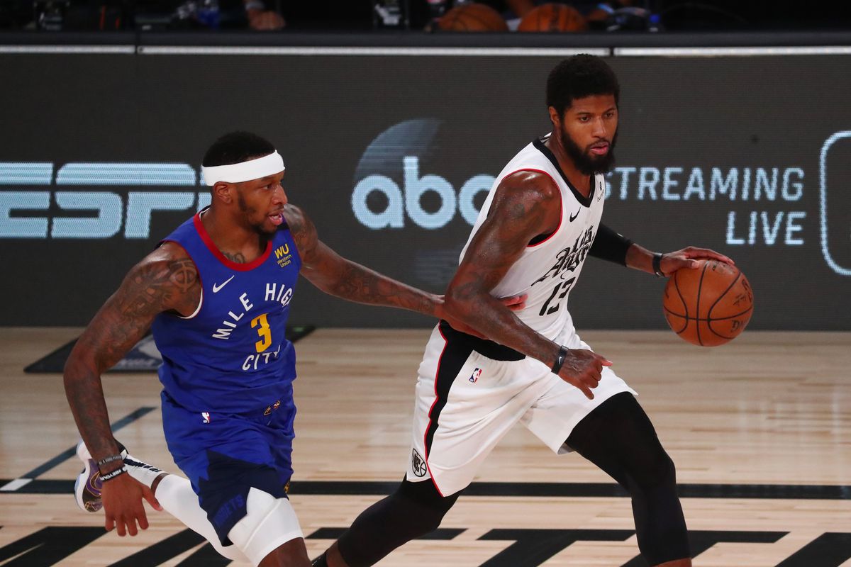 &nbsp;Paul George of the LA Clippers controls the ball Torrey Craig of the Denver Nuggets in the second quarter at AdventHealth Arena at ESPN Wide World Of Sports Complex on August 12, 2020 in Lake Buena Vista, Florida.