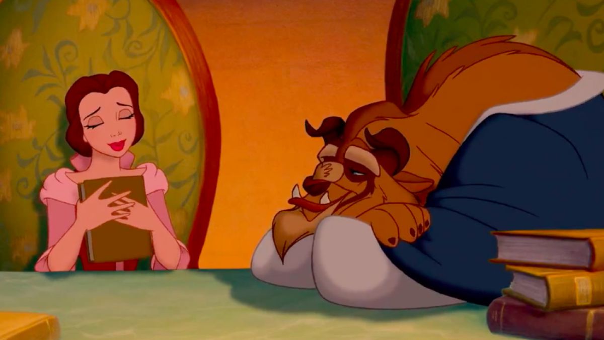 belle clutching a book to her chest and smiling, while the beast rests his head on the table, but looks up at her adoringly