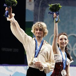 Americans Charlie White and Meryl Davis wave from the podium after winning the silver medal in the ice dance figure skating competition at the Vancouver 2010 Olympics Monday.