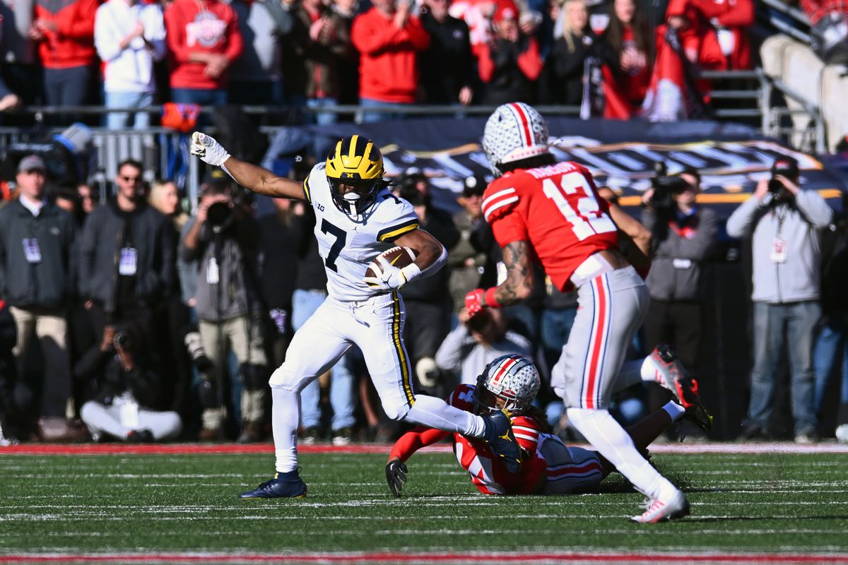 Donovan Edwards #7 of the Michigan Wolverines evades a tackle during the second quarter of a game against the Ohio State Buckeyes at Ohio Stadium on November 26, 2022 in Columbus, Ohio.