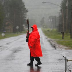 A corrections officer works at a roadblock as the search continues for two prison escapees from Clinton Correctional Facility in Dannemora, on Tuesday, June 23, 2015, in Owls Head, N.Y.  Police began focusing intensely on the area 20 miles west of the prison that inmates David Sweat and Richard Matt escaped on June 6. 