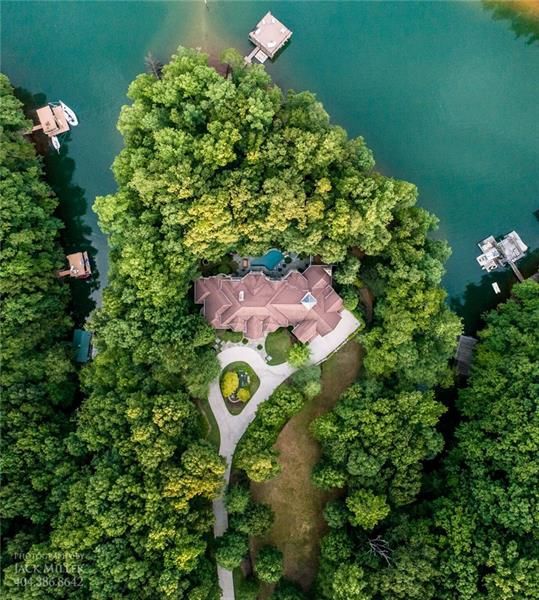 A drone image of a huge house on a big lake. 