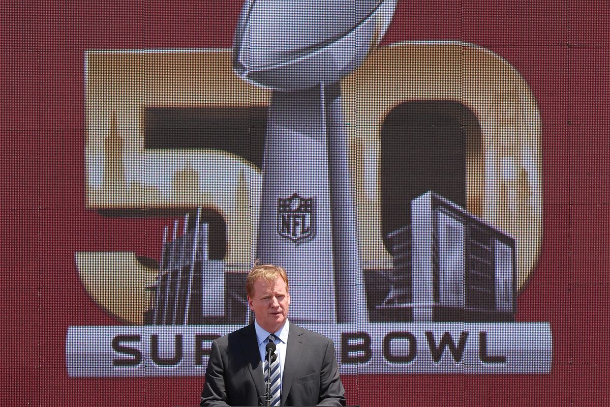 Roger Goodell in front of the Super Bowl 50 logo