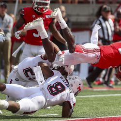 Utah Utes quarterback Tyler Huntley (1) dives over the Northern Illinois Huskies defense and into the end zone for a touchdown during first-half action at Rice-Eccles Stadium in Salt Lake City on Saturday, Sept. 7, 2019.