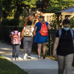 Parents and students arrive Monday at George Armstrong Elementary School in Rogers Park for the first day of school for Chicago Public Schools.