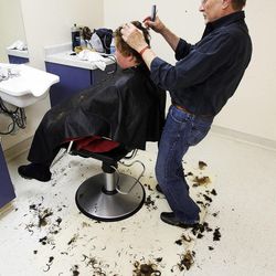 Stuart Stone cuts Heather Hertig's hair at the Weigand Homeless Day Center in Salt Lake City, Monday, April 8, 2013.