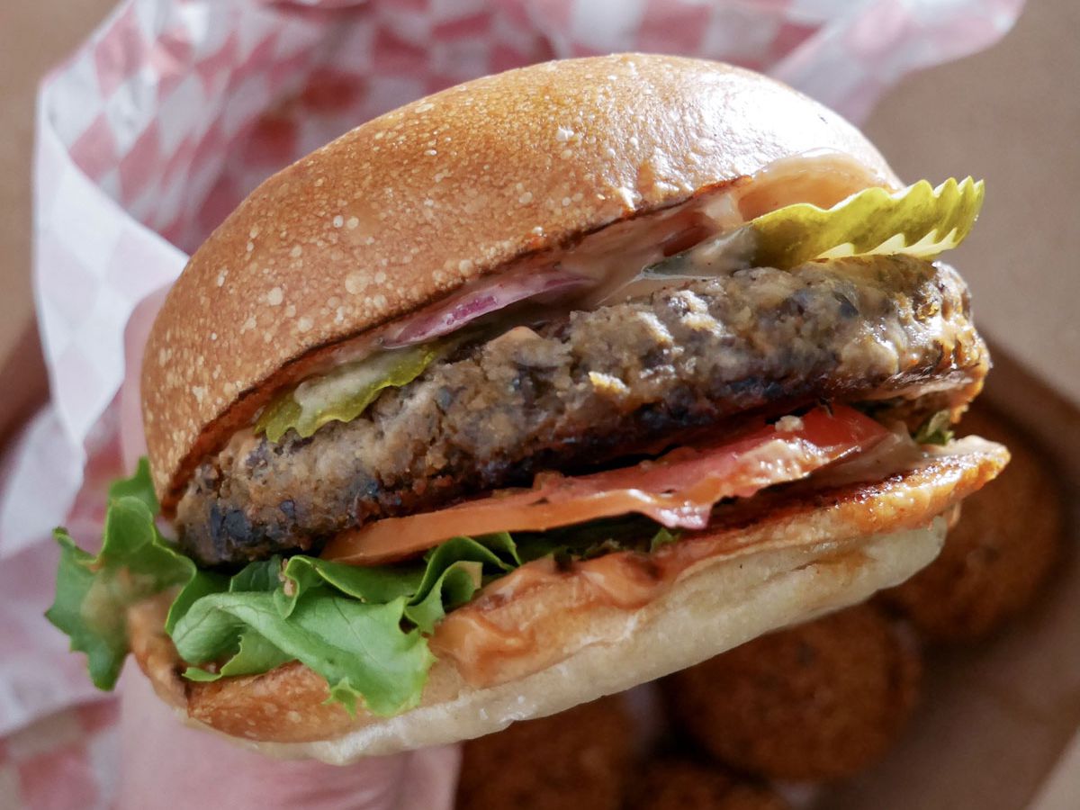 A photo of the SxNW bourbon burger with a black bean patty
