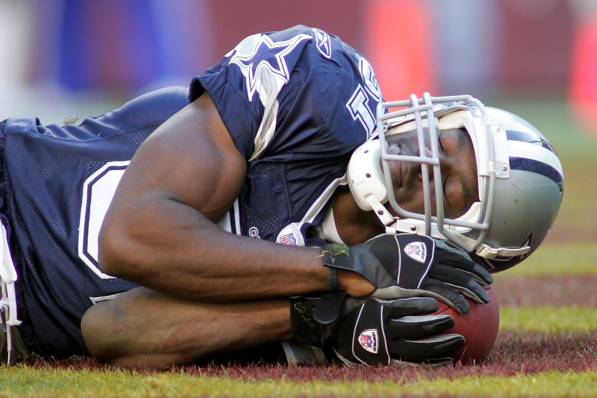 Dallas wide receiver Terrell Owens (81) pretends to sleep in