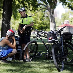Salt Lake City police officer Harrison Livsey talks with an individual at Pioneer Park in Salt Lake City on Wednesday, June 1, 2016.