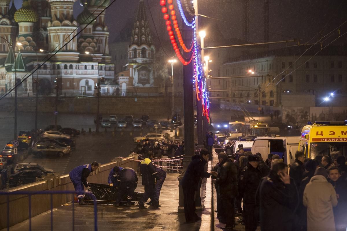Medics put the the body of Boris Nemtsov, a former Russian deputy prime minister and opposition leader on a stretcher at Red Square with St. Basil Cathedral in the background in Moscow, Russia, Saturday, Feb. 28, 2015.