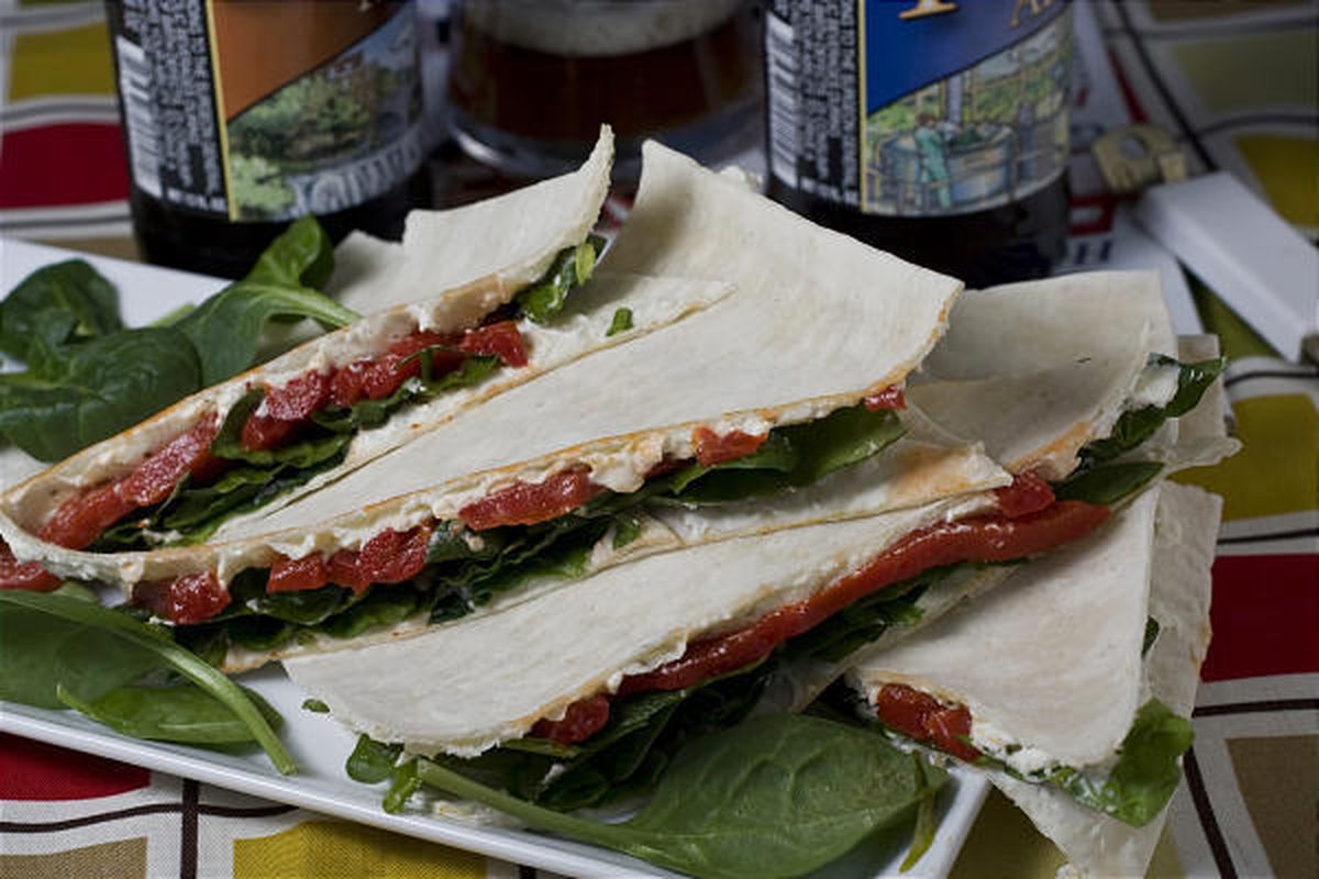 Roasted red pepper and spinach flatbread sandwiches.  A combination of cheese and veggies blend together to make these roasted red pepper and spinach flatbread sandwiches a good option to the usual Italian sub for Super Bowl noshing. 