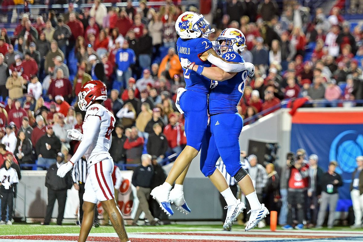 Mason Fairchild #89 and Lawrence Arnold #2 of the Kansas Jayhawks celebrate during the first half of the AutoZone Liberty Bowl game against the Arkansas Razorbacks at Simmons Bank Liberty Stadium on December 28, 2022 in Memphis,