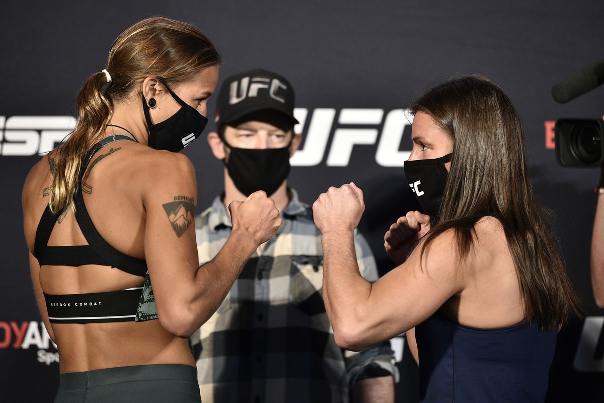 In this handout image provided by UFC, opponents Mariya Agapova of Kazakhstan and Hannah Cifers face off during the UFC Fight Night weigh-in at UFC APEX on June 12, 2020 in Las Vegas, Nevada.