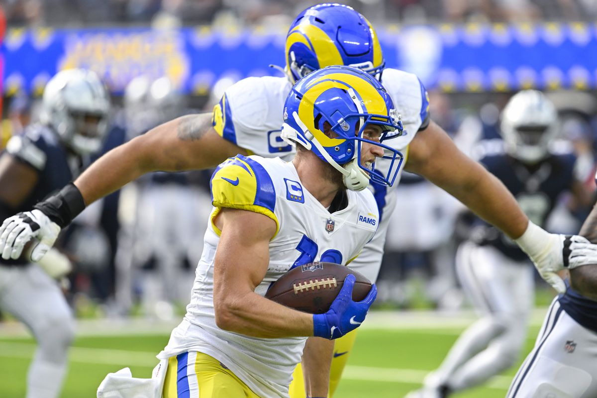 Los Angeles Rams wide receiver Cooper Kupp (10) carries the ball as offensive tackle Rob Havenstein (79) follows during the second quarter against the Dallas Cowboys at SoFi Stadium.