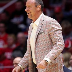 Utah Utes head coach Larry Krystkowiak smiles as he talks to one of his players as Utah and UC Davis play in an NIT basketball game at the Huntsman Center in Salt Lake City on Wednesday, March 14, 2018. Utah won 69-59.
