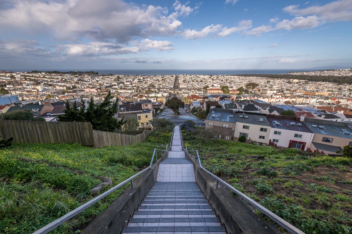 View of San Francisco from the top of a set of mosaic stairs.