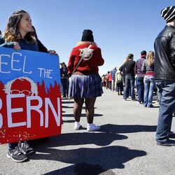 Bernadette High, of Layton, left, holds a sign in support of Democratic presidential candidate and Vermont Sen. Bernie Sanders as she waits in line before Sanders gives a speech at This is the Place Heritage Park in Salt Lake City, Friday, March 18, 2016.