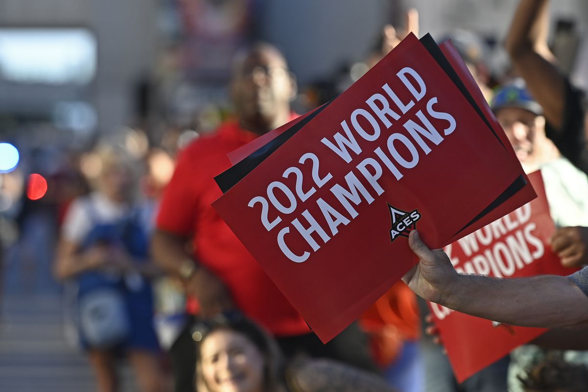 People hold signs supporting the Las Vegas Aces during the 2022 WNBA championship parade on the Las Vegas Strip on September 20, 2022 in Las Vegas, Nevada