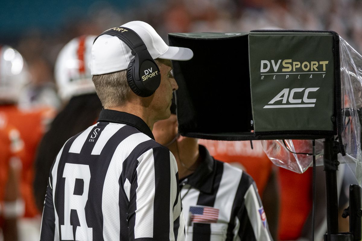 College football referee Jeff Heaser reviews a play on the replay monitor during the college football game between the Virginia Cavaliers and the University of Miami Hurricanes on September 30, 2021 at the Hard Rock Stadium in Miami Gardens, FL.